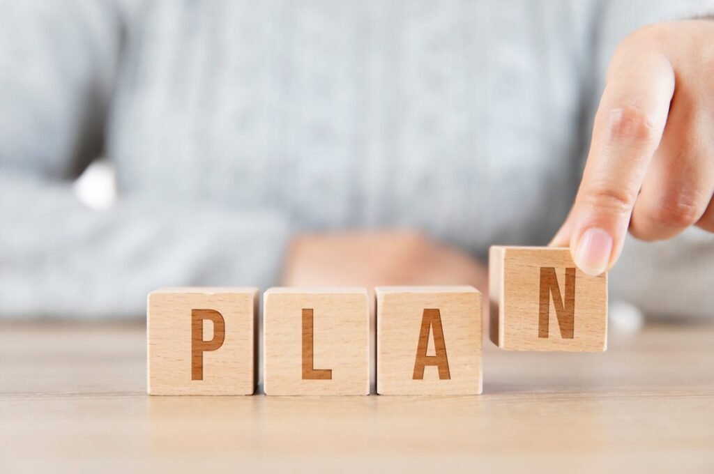 Wooden blocks spelling PLAN